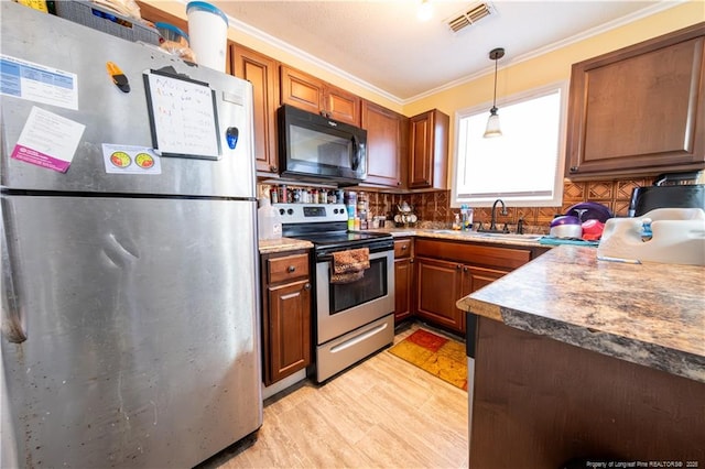 kitchen with sink, stainless steel appliances, backsplash, pendant lighting, and ornamental molding