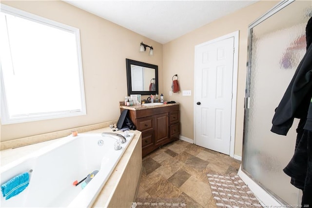 bathroom with vanity and shower with separate bathtub