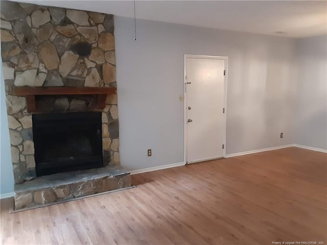 unfurnished living room with a fireplace and wood-type flooring