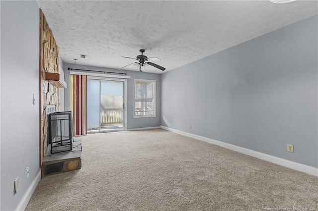 unfurnished living room featuring a textured ceiling, carpet floors, and ceiling fan