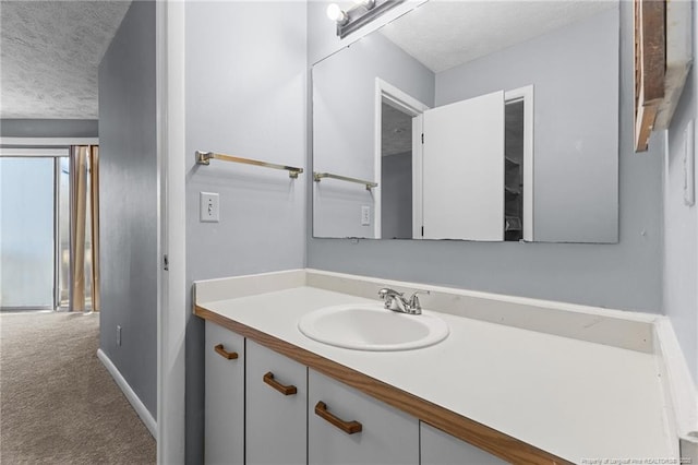 bathroom featuring a textured ceiling and vanity