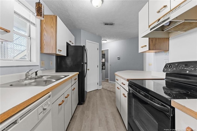 kitchen with dishwasher, black electric range, white cabinets, and sink