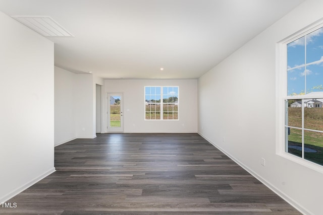 empty room featuring dark hardwood / wood-style flooring