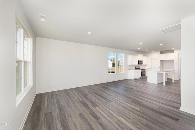 unfurnished living room with dark hardwood / wood-style floors