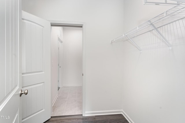 walk in closet with wood-type flooring