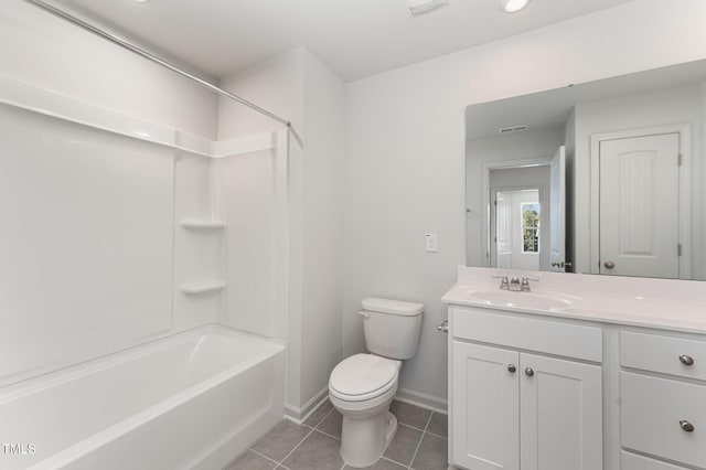 full bathroom featuring toilet, vanity, tile patterned floors, and washtub / shower combination