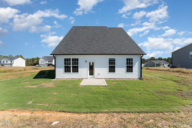 rear view of house featuring a patio area and a yard