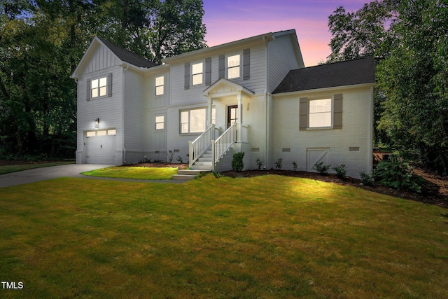 view of front of property with a yard and a garage