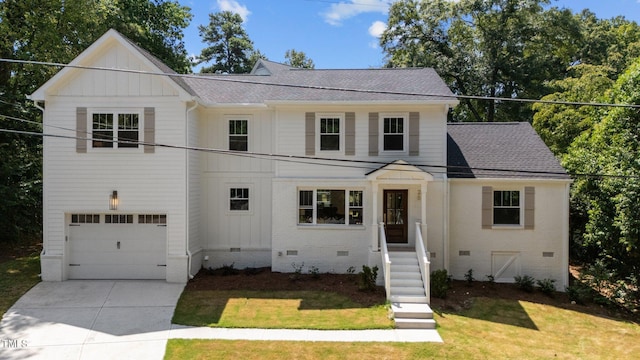 view of front of home with a front yard and a garage