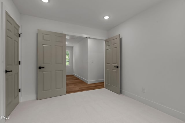 unfurnished bedroom with light carpet