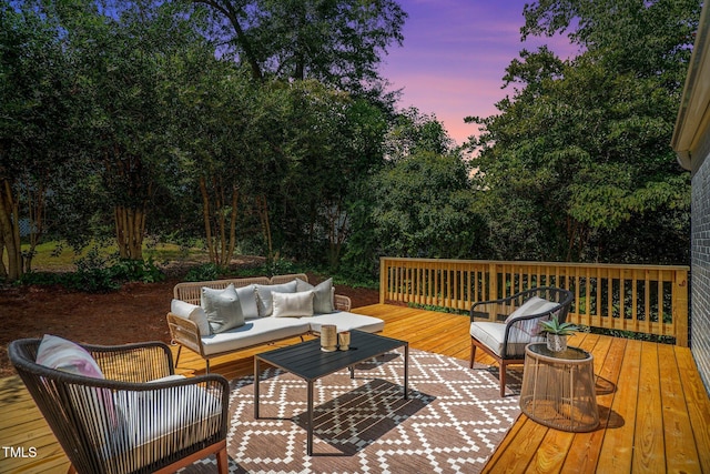 deck at dusk featuring an outdoor hangout area