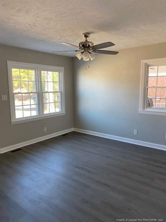 empty room featuring ceiling fan, dark hardwood / wood-style flooring, and a textured ceiling