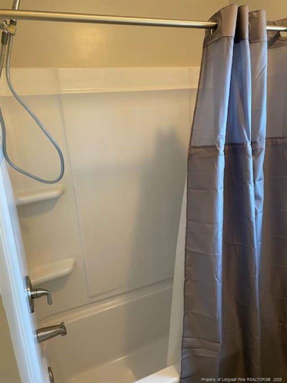 bathroom with shower / tub combo with curtain