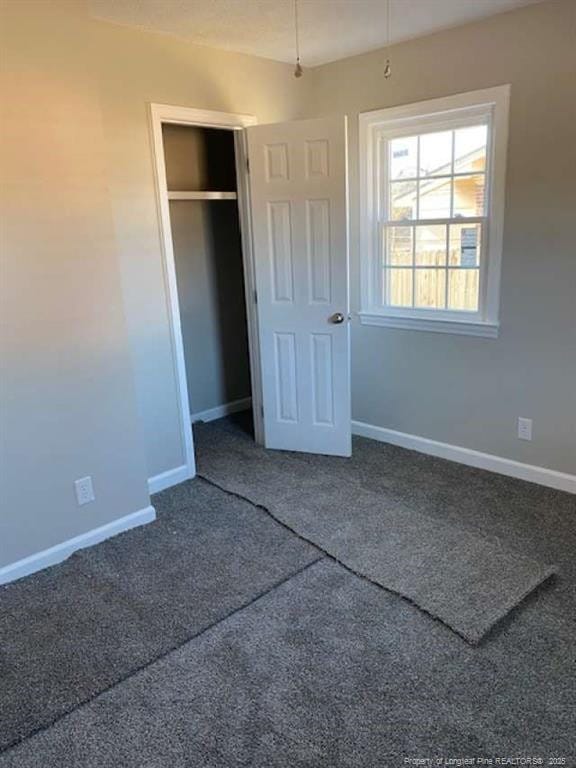 unfurnished bedroom with carpet and a closet