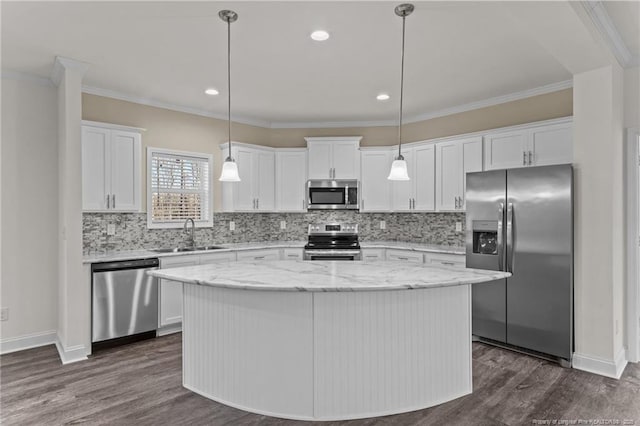 kitchen with white cabinets, a center island, stainless steel appliances, and sink