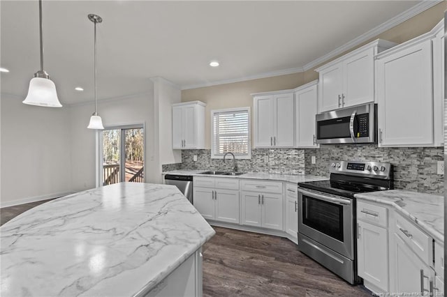 kitchen featuring tasteful backsplash, stainless steel appliances, sink, pendant lighting, and white cabinetry