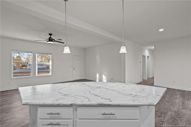 kitchen with a center island, decorative light fixtures, and white cabinetry