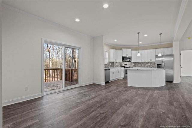 kitchen featuring white cabinetry, dark hardwood / wood-style floors, decorative light fixtures, a kitchen island, and appliances with stainless steel finishes