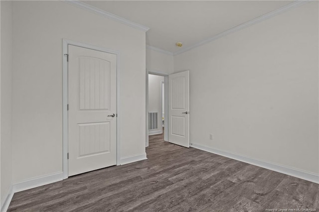 unfurnished bedroom with dark hardwood / wood-style flooring and crown molding