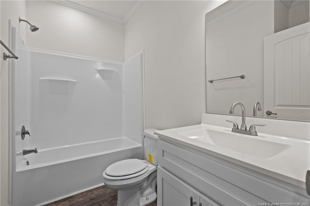 full bathroom with vanity, bathing tub / shower combination, crown molding, hardwood / wood-style floors, and toilet