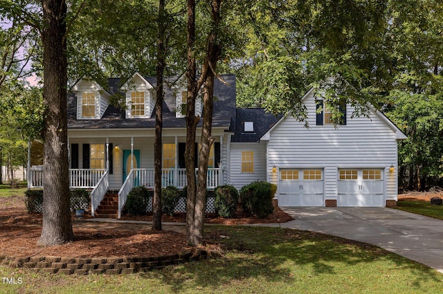 cape cod home featuring covered porch and a garage