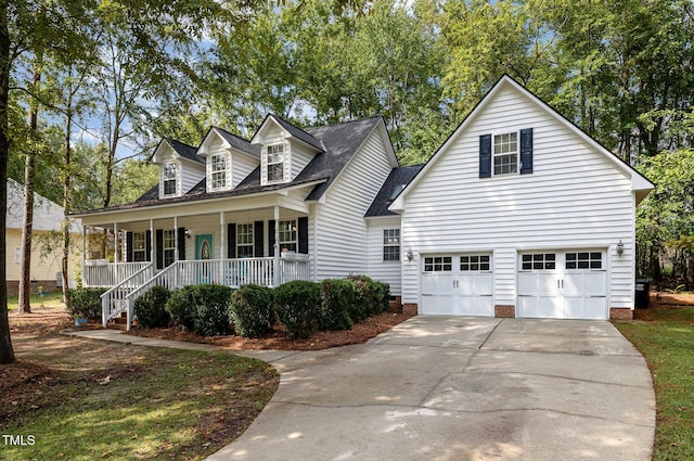 new england style home featuring covered porch and a garage