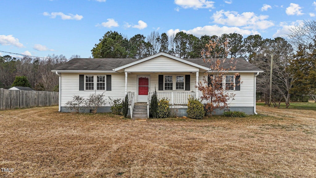 ranch-style house with a front lawn and covered porch