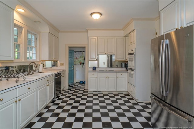 kitchen featuring cooktop, a sink, freestanding refrigerator, dark floors, and light countertops