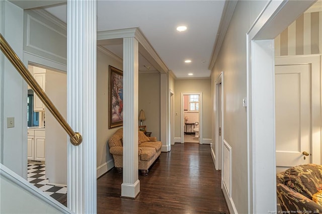 hallway featuring ornate columns, stairway, dark wood-style flooring, baseboards, and ornamental molding