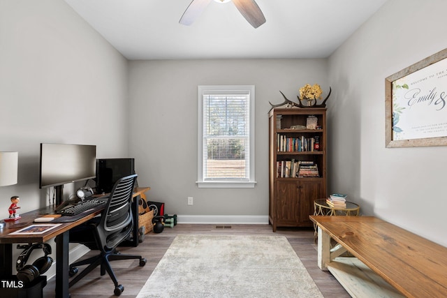 office with hardwood / wood-style floors and ceiling fan