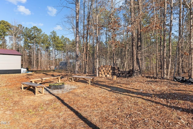 view of yard with an outdoor fire pit