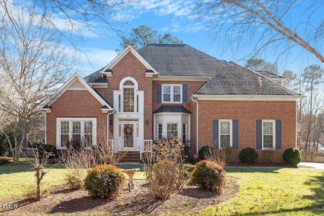 view of property featuring a front lawn