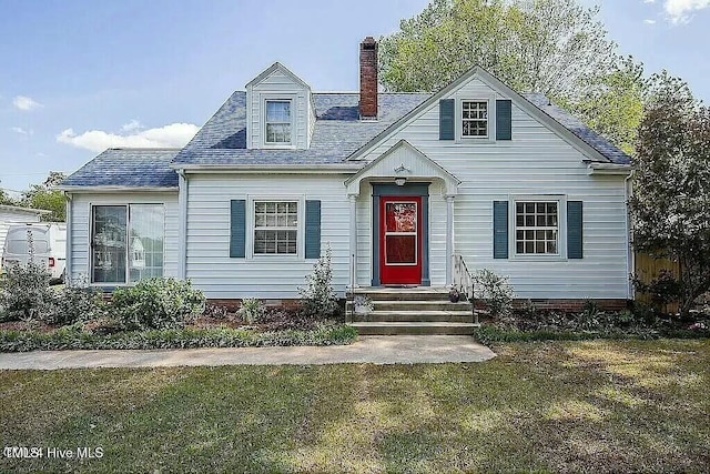 cape cod house with a front yard