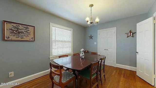 dining area featuring a chandelier, hardwood / wood-style flooring, and a baseboard radiator