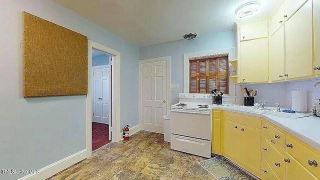 kitchen with white range with electric stovetop and sink