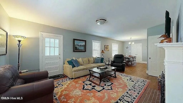 living room featuring dark wood-type flooring and a notable chandelier