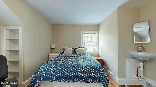 bedroom with hardwood / wood-style flooring