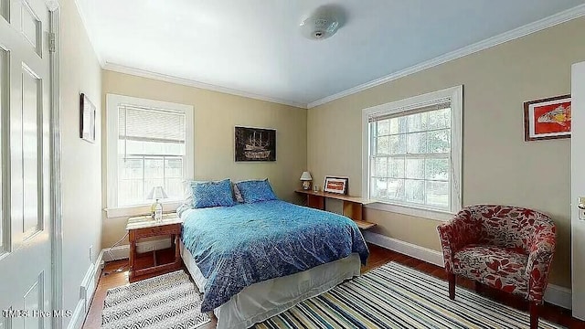 bedroom featuring crown molding and hardwood / wood-style floors