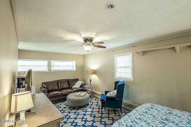 living room featuring a textured ceiling and ceiling fan