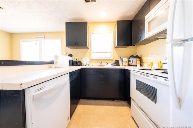 kitchen with white appliances and kitchen peninsula