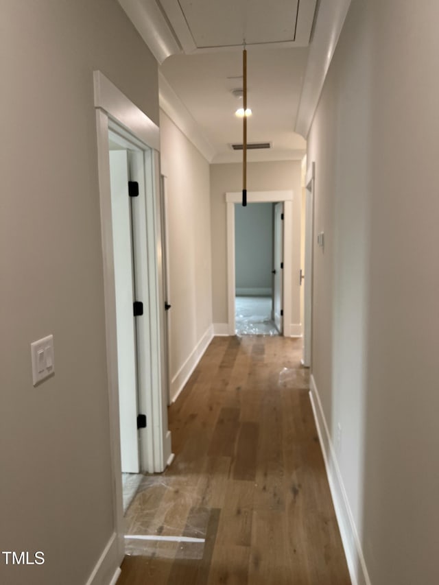 hall featuring wood-type flooring and ornamental molding