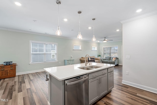 kitchen featuring sink, ceiling fan, dishwasher, hanging light fixtures, and an island with sink