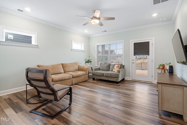 living room featuring dark hardwood / wood-style flooring, crown molding, and ceiling fan