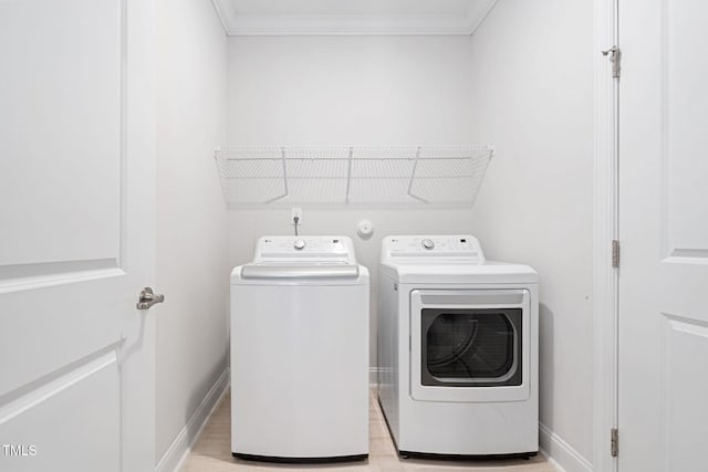 washroom with ornamental molding and separate washer and dryer