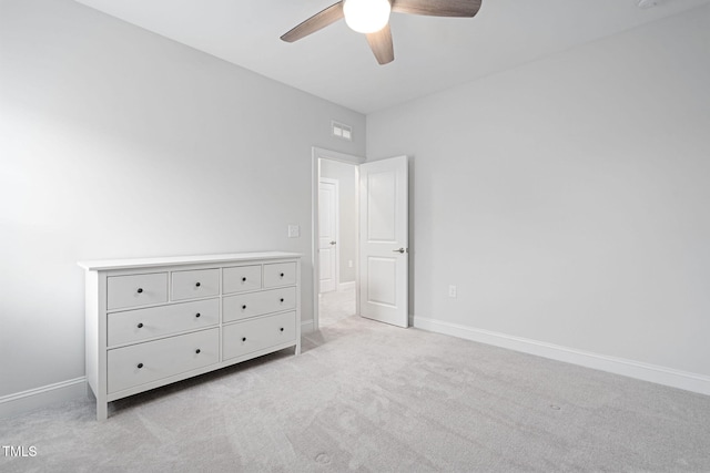 unfurnished bedroom featuring light carpet and ceiling fan