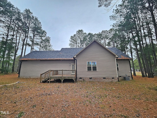 rear view of property featuring central air condition unit and a deck