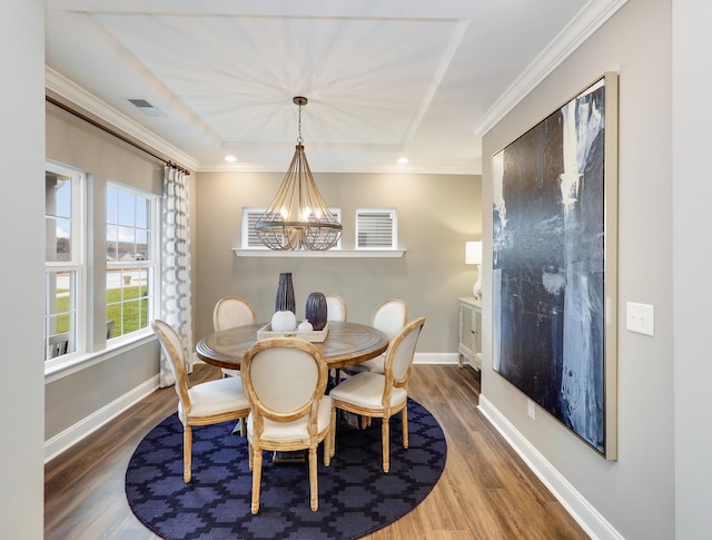 dining space featuring crown molding, dark hardwood / wood-style flooring, and a notable chandelier