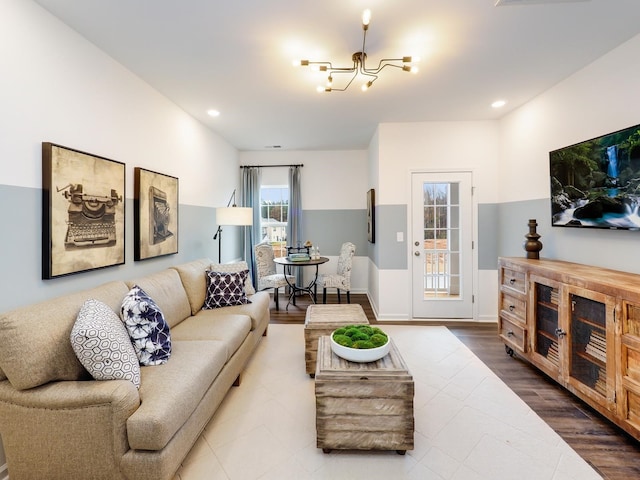 living room with hardwood / wood-style floors and a chandelier