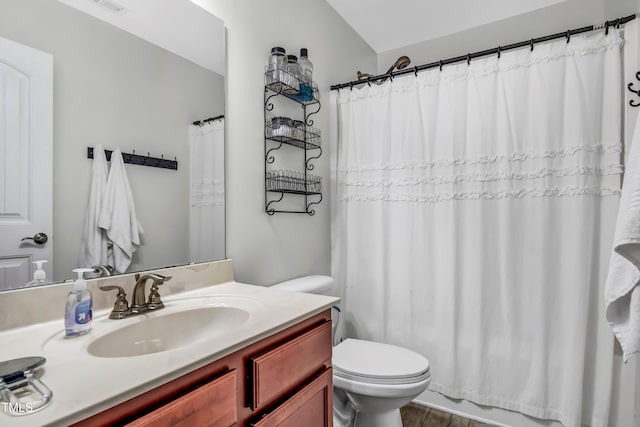 full bathroom featuring toilet, vanity, and shower / bath combo with shower curtain