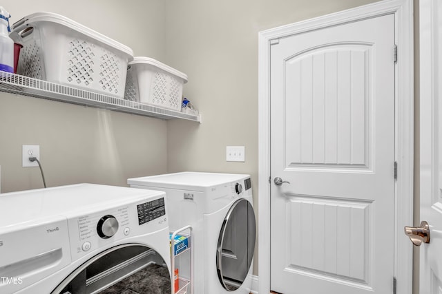 clothes washing area featuring washer and dryer